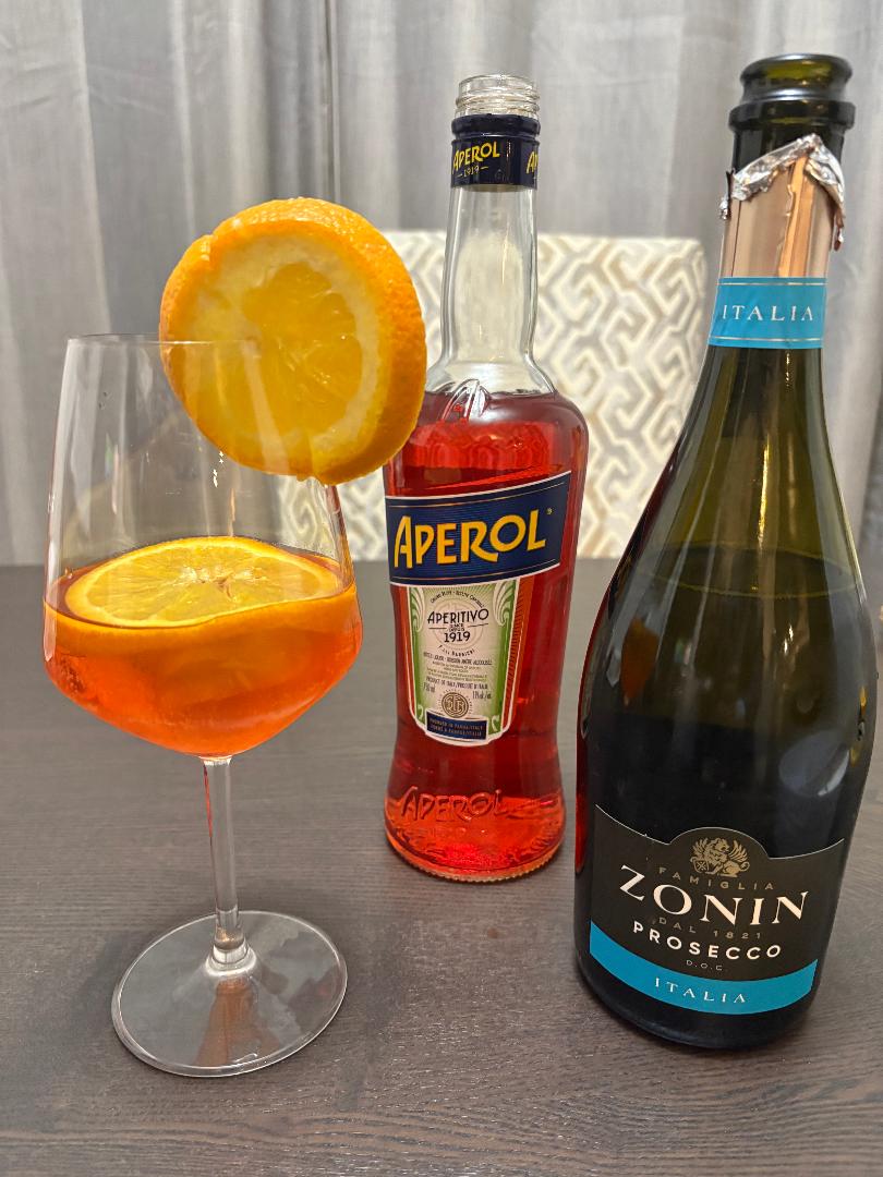 Aperol Spritz with Aperol bottle and Prosecco for an aperitivo night at home